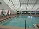 Indoor pool with a retractable roof and seating area at 6435 Borg St, Leesburg, FL 34748