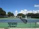 Well-maintained tennis courts with seating area at 6435 Borg St, Leesburg, FL 34748