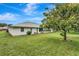 House backyard with large grassy area and trees at 6435 Borg St, Leesburg, FL 34748