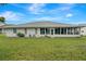 Spacious backyard with grassy lawn and screened enclosure at 6435 Borg St, Leesburg, FL 34748