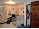 Cozy bedroom with crib, dresser, and wood closet at 16640 Ne 148Th Terrace Rd, Fort Mc Coy, FL 32134