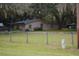 Ranch home with a large backyard and wooden fence at 16640 Ne 148Th Terrace Rd, Fort Mc Coy, FL 32134
