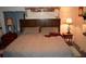 Spacious main bedroom with king-size bed and wood headboard at 16640 Ne 148Th Terrace Rd, Fort Mc Coy, FL 32134