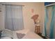 Bedroom with full bed, fan, and light-blue curtains at 16640 Ne 148Th Terrace Rd, Fort Mc Coy, FL 32134