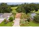 Aerial view of a house and surrounding area, with a pond and open field at 7151 Se 173Rd Arlington Loop, The Villages, FL 32162