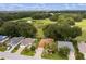 Aerial view of a house and surrounding area, with a pond and open field at 7151 Se 173Rd Arlington Loop, The Villages, FL 32162