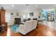 Bright living room with hardwood floors, a fireplace, and ample natural light at 7151 Se 173Rd Arlington Loop, The Villages, FL 32162
