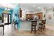 Kitchen with light wood cabinets, granite countertops, and breakfast bar at 7151 Se 173Rd Arlington Loop, The Villages, FL 32162
