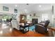 Relaxing living room with hardwood floors, fireplace, and comfortable seating at 7151 Se 173Rd Arlington Loop, The Villages, FL 32162