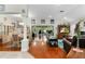 Open living room and dining area with hardwood floors and wood-burning fireplace at 7151 Se 173Rd Arlington Loop, The Villages, FL 32162