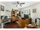 Home office with built-in shelving and wood floors at 7151 Se 173Rd Arlington Loop, The Villages, FL 32162