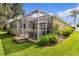 Home's exterior with a screened patio and lush landscaping at 7151 Se 173Rd Arlington Loop, The Villages, FL 32162