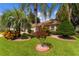 Landscaped front yard with lush tropical plants at 7151 Se 173Rd Arlington Loop, The Villages, FL 32162