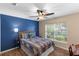 Bedroom with a full-size bed, ceiling fan, and wood flooring at 1914 Iglesia St, The Villages, FL 32159