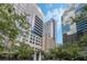 Luxury high-rise building with a fountain and lush landscaping at 155 S Court Ave # 1507, Orlando, FL 32801