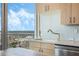 Modern kitchen with light wood cabinets and a gold faucet at 155 S Court Ave # 1507, Orlando, FL 32801