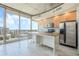 Modern kitchen with island, stainless steel appliances, and marble floors at 155 S Court Ave # 1507, Orlando, FL 32801