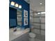 Modern bathroom with blue and gray color scheme and a glass shower at 5143 Firebush Dr, Apopka, FL 32712