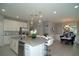 Open kitchen with white cabinetry, granite counters and breakfast bar at 5143 Firebush Dr, Apopka, FL 32712