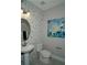 Stylish bathroom with a unique pebble tile accent wall and a pedestal sink at 5143 Firebush Dr, Apopka, FL 32712
