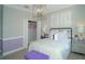 Charming bedroom with a purple and gray color scheme, featuring a comfortable bed and ample closet space at 5143 Firebush Dr, Apopka, FL 32712