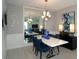 Elegant dining room featuring a white table and blue chairs at 86 Spaderdock Ln, Apopka, FL 32712