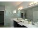 Double vanity bathroom with a large mirror and shower at 5143 Firebush Dr, Apopka, FL 32712