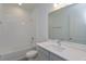 Bathroom with tub, single vanity, and neutral tile at 2375 Juniper Berry Dr, Minneola, FL 34715