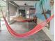 Relaxing patio with two hammocks and beach mural at 1304 Ocoee Apopka Rd, Ocoee, FL 34761