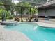 Inviting freeform pool with covered patio at 1304 Ocoee Apopka Rd, Ocoee, FL 34761