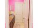 Pink bathroom with a single sink and granite countertop at 1304 Ocoee Apopka Rd, Ocoee, FL 34761