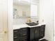 Modern bathroom vanity with black cabinets and gold hardware at 1304 Ocoee Apopka Rd, Ocoee, FL 34761