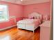 Charming bedroom with hardwood floors and a white bed frame at 1304 Ocoee Apopka Rd, Ocoee, FL 34761