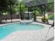 Relaxing screened pool and spa with ample patio space at 1304 Ocoee Apopka Rd, Ocoee, FL 34761