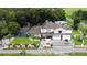 Two story house with pool, lush landscaping, and large driveway at 1304 Ocoee Apopka Rd, Ocoee, FL 34761