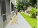 Landscaped walkway beside home's exterior at 1304 Ocoee Apopka Rd, Ocoee, FL 34761