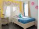 Bedroom with a white bed frame and yellow walls at 1304 Ocoee Apopka Rd, Ocoee, FL 34761