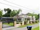 Two-story home with solar panels, pool, and gated entry at 1304 Ocoee Apopka Rd, Ocoee, FL 34761