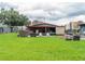 Large backyard with covered patio and fire pit at 1817 Demastus Ln, Ocoee, FL 34761
