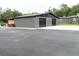 Large detached garage with black doors at 1817 Demastus Ln, Ocoee, FL 34761
