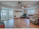 Living room with laminate floors, couches, and a view of a sunroom at 853 Cr 484, Lake Panasoffkee, FL 33538
