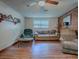 Living room with laminate wood floor, couches, and stone accent wall at 853 Cr 484, Lake Panasoffkee, FL 33538