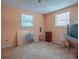 Bright bedroom with wood floors and two windows at 853 Cr 484, Lake Panasoffkee, FL 33538