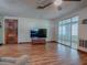 Living room with laminate floors, sliding doors, and a TV at 853 Cr 484, Lake Panasoffkee, FL 33538