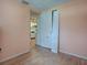 Simple bedroom with wood floors and kitchen view at 853 Cr 484, Lake Panasoffkee, FL 33538