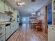 Kitchen with light green cabinets, wood floors and a dining area at 853 Cr 484, Lake Panasoffkee, FL 33538