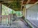Covered patio with wooden decking and chain-link fence at 853 Cr 484, Lake Panasoffkee, FL 33538