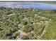 Aerial view showing a lot surrounded by trees and a lake at 853 Cr 484, Lake Panasoffkee, FL 33538