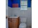 Small bathroom with white tile and wood vanity at 853 Cr 484, Lake Panasoffkee, FL 33538