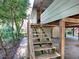 Wooden stairs leading to elevated home exterior at 853 Cr 484, Lake Panasoffkee, FL 33538